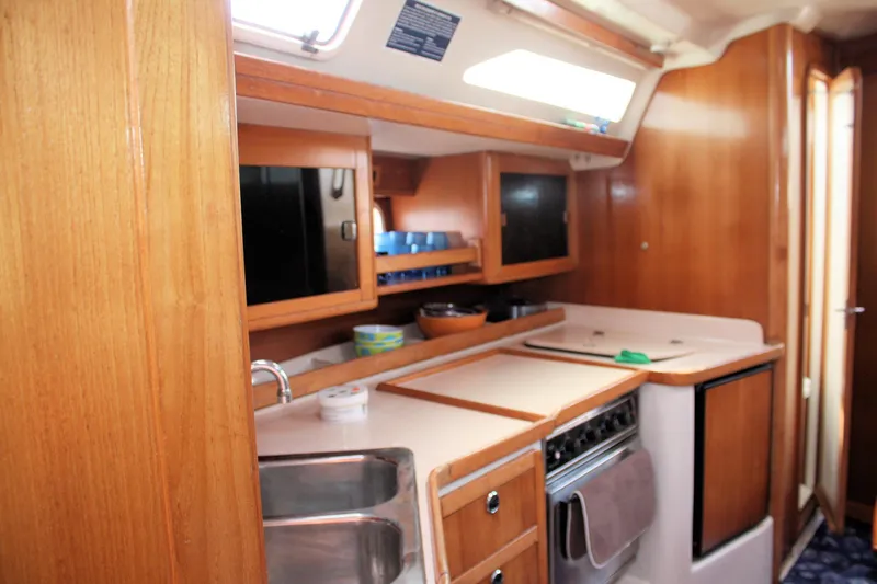 Slide: The Image of Interior of 1998 Catalina 42 MkII yacht kitchen with wooden cabinetry and appliances. - 36