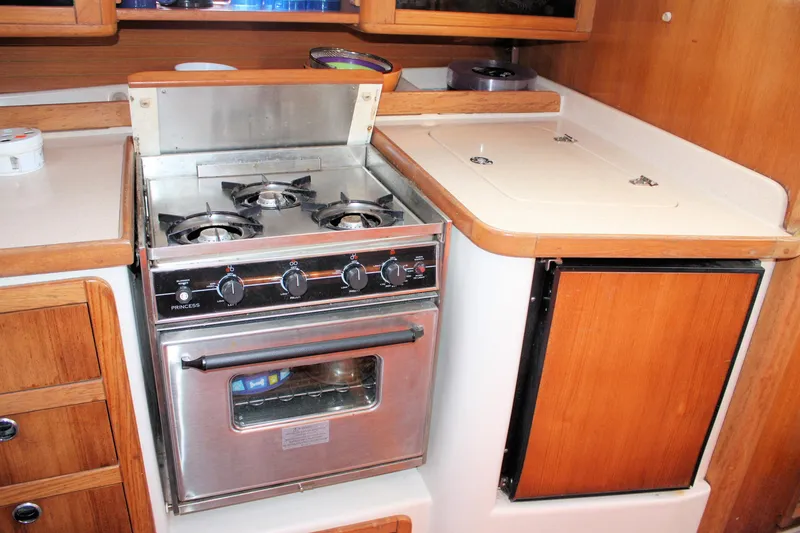 Slide: The Image of Galley kitchen in 1998 Catalina 42 MkII sailboat with stove and wooden cabinetry. - 37
