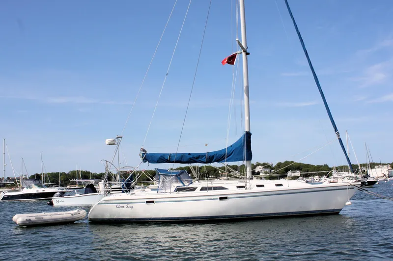 Slide: The Image of 1998 Catalina 42 MkII sailboat anchored in a marina with clear skies. - 4