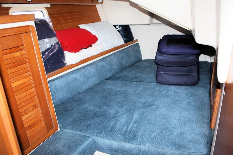 Slide: The Image of Cozy cabin interior of 1998 Catalina 42 MkII sailboat with blue cushions and wooden accents. - 44