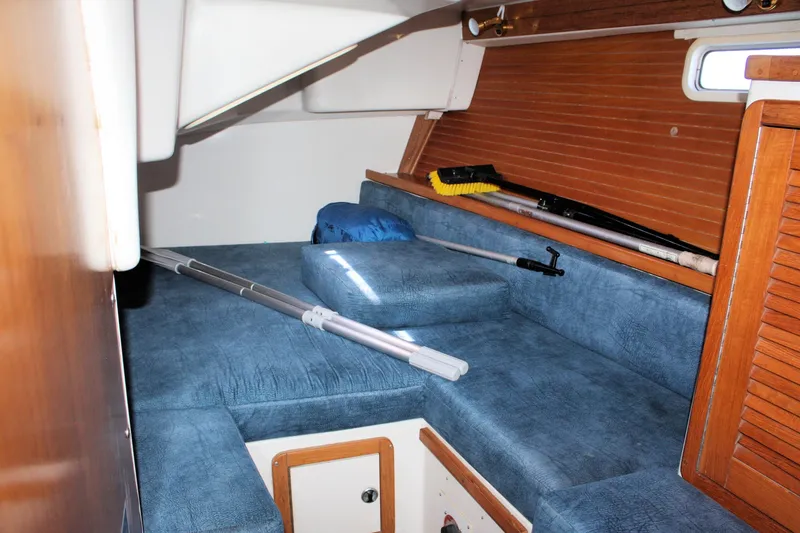 Slide: The Image of Interior cabin of a 1998 Catalina 42 MkII sailboat with blue upholstery and cleaning tools. - 45