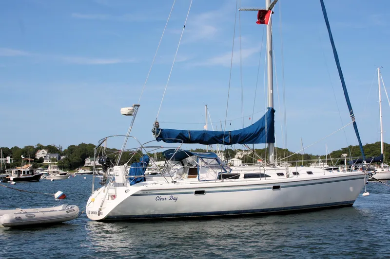Slide: The Image of Sailboat Catalina 42 MkII 1998 anchored in a scenic harbor with clear skies. - 5