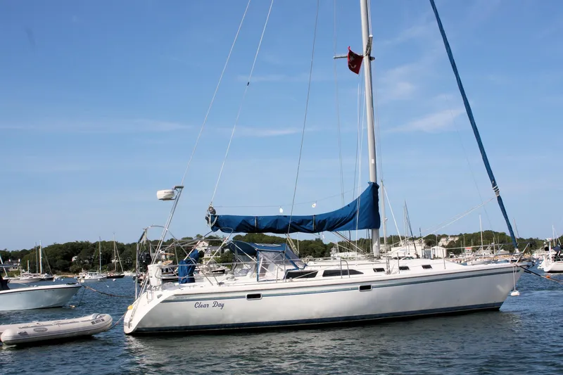 Slide: The Image of 1998 Catalina 42 MkII sailboat anchored in a marina on a clear day. - 6