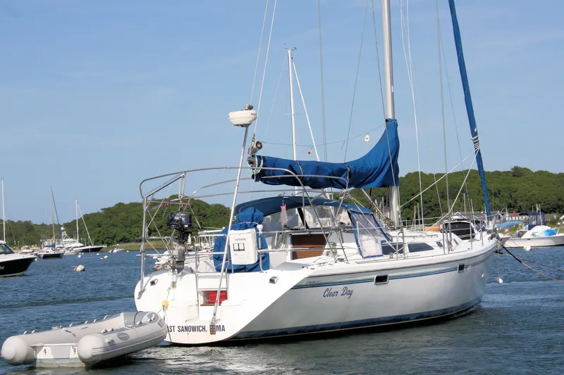 Slide: The Image of Sailboat Catalina 42 MkII, 1998 model, anchored in a scenic harbor with lush greenery. - 9