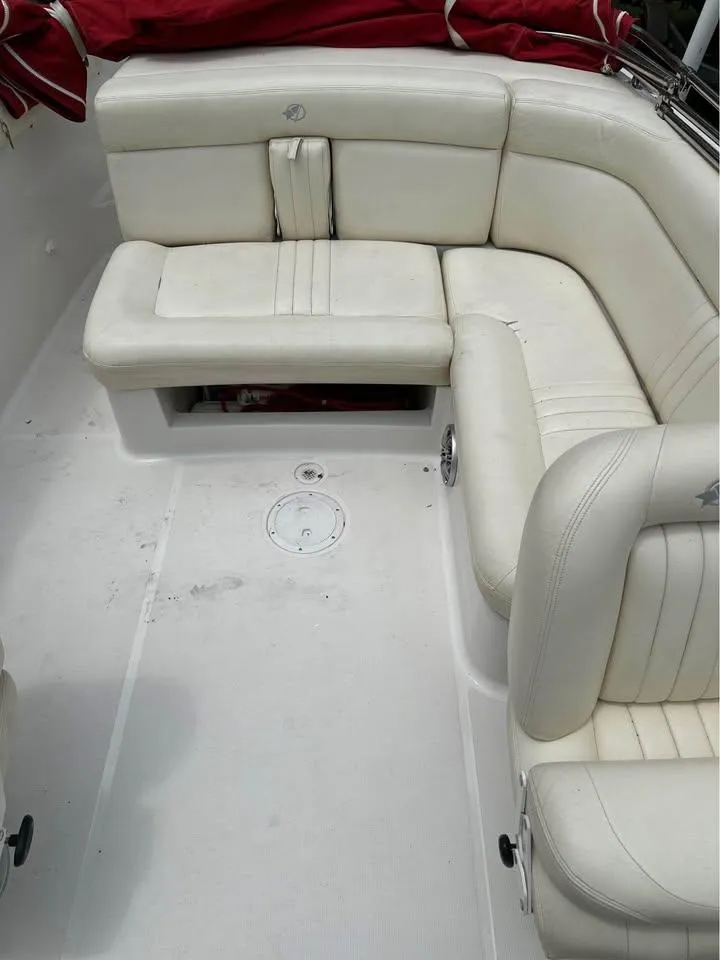 Slide: The Image of 2001 Chris-Craft Launch 22 boat interior with white leather seating and red cover. - 7