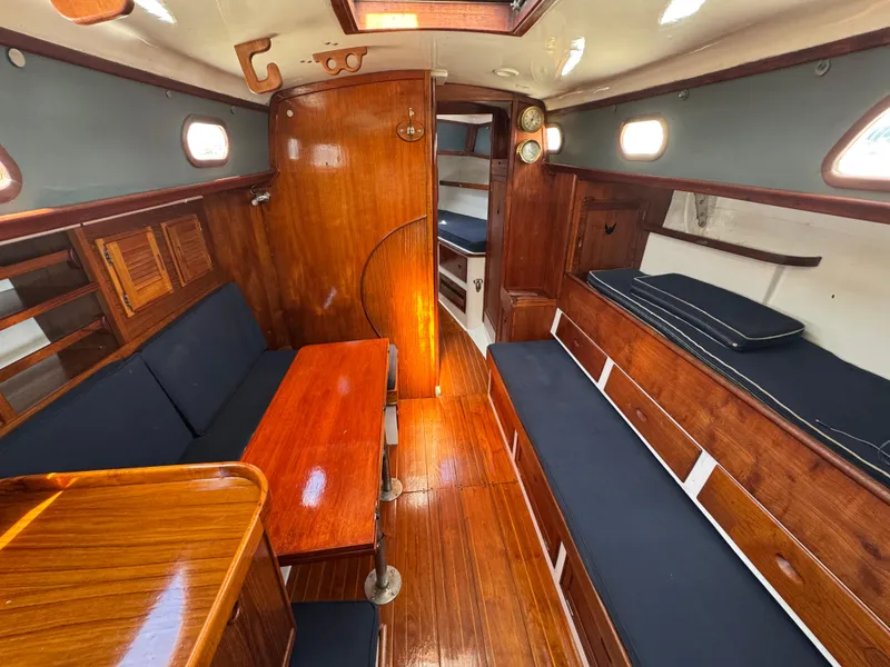 Slide: The Image of 1970 Cheoy Lee Luders 36 yacht interior with wooden finish and blue seating. - 25