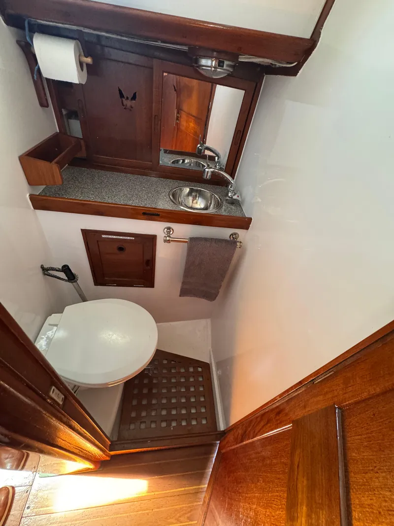 Slide: The Image of 1970 Cheoy Lee Luders 36 yacht bathroom with wooden accents and compact design. - 26