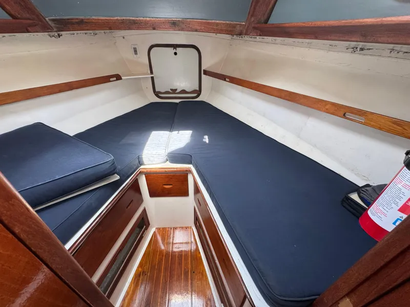 Slide: The Image of 1970 Cheoy Lee Luders 36 cabin interior with wooden finish and blue cushions. - 28