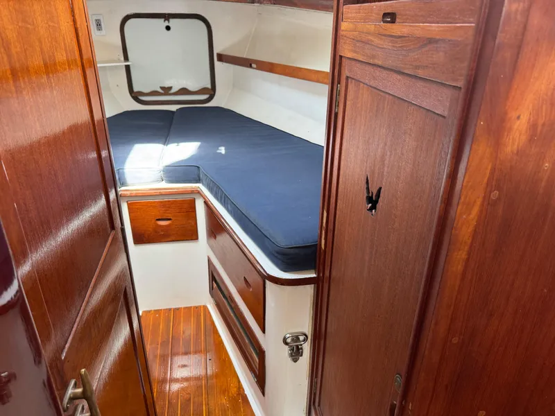 Slide: The Image of 1970 Cheoy Lee Luders 36 cabin interior with wooden finish and blue cushions. - 29