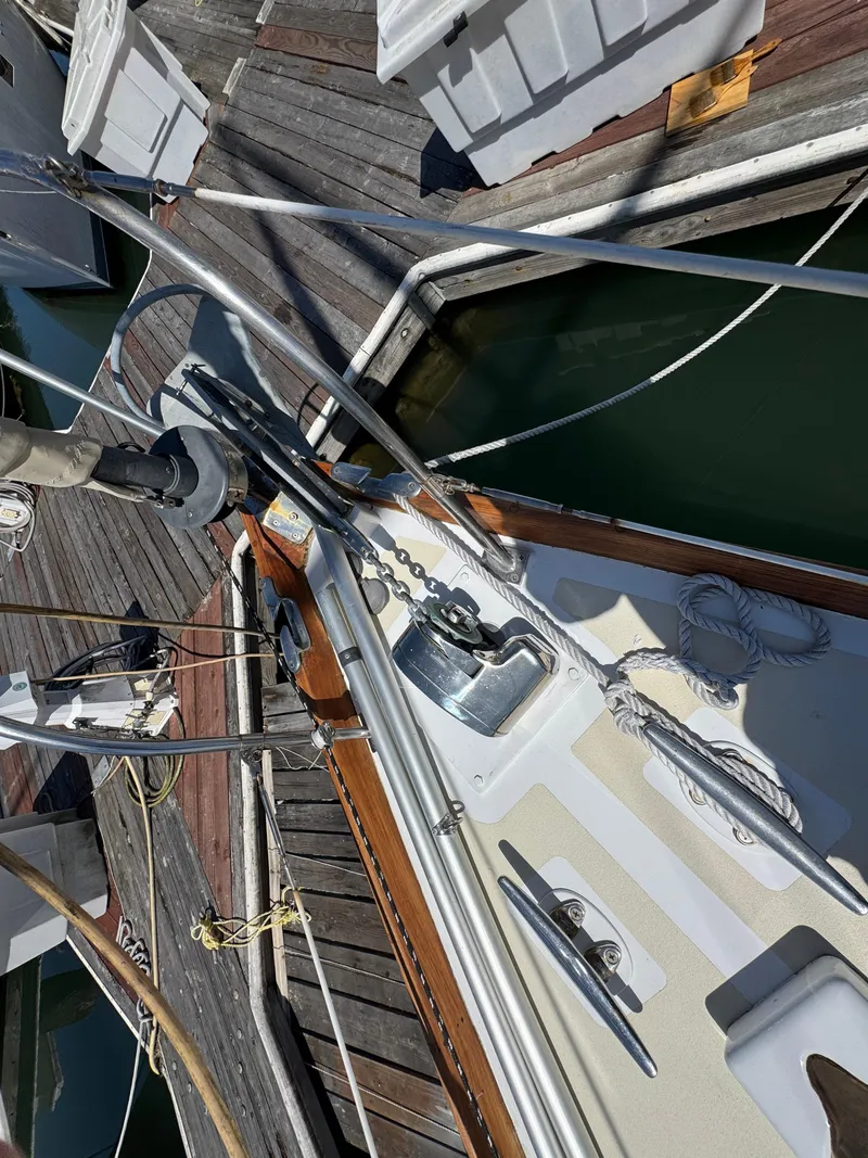 Slide: The Image of 1970 Cheoy Lee Luders 36 sailboat deck with ropes and winch, docked at marina. - 33
