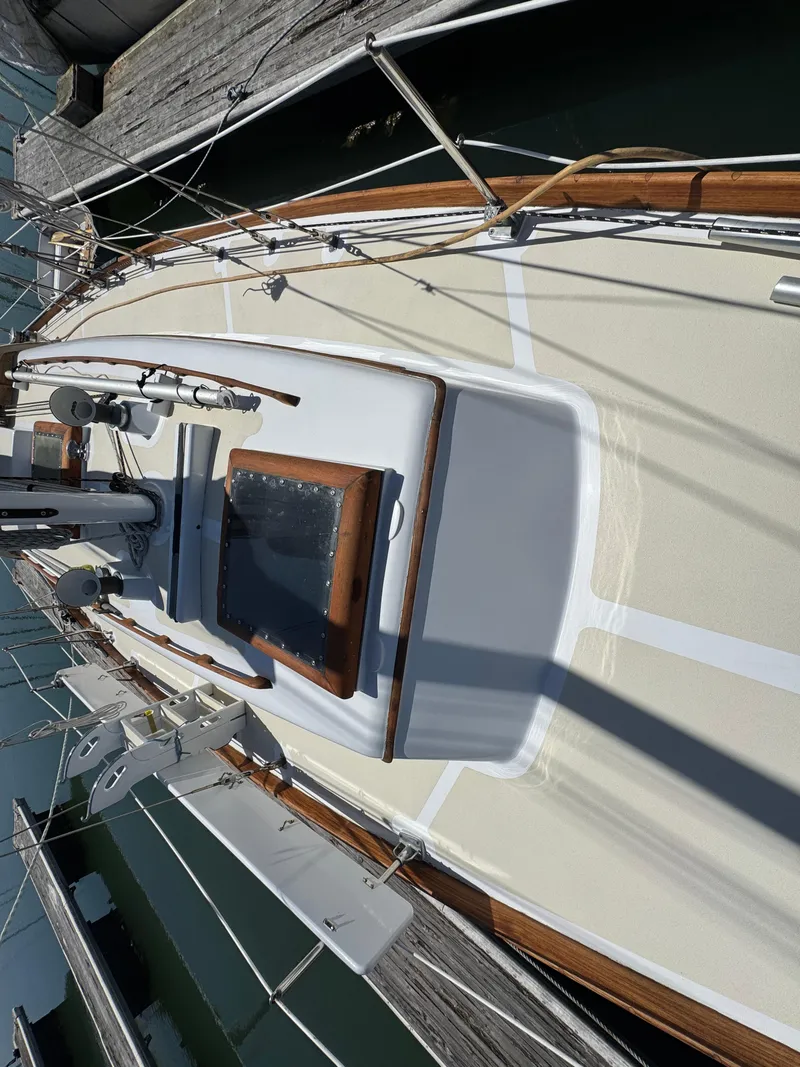 Slide: The Image of 1970 Cheoy Lee Luders 36 sailboat deck with wooden trim, docked at marina. - 34