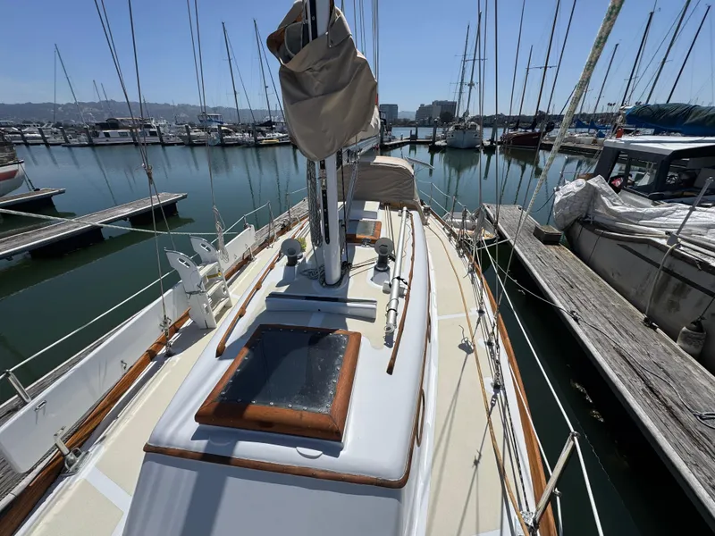 Slide: The Image of 1970 Cheoy Lee Luders 36 sailboat docked at a marina, showcasing deck and rigging. - 35