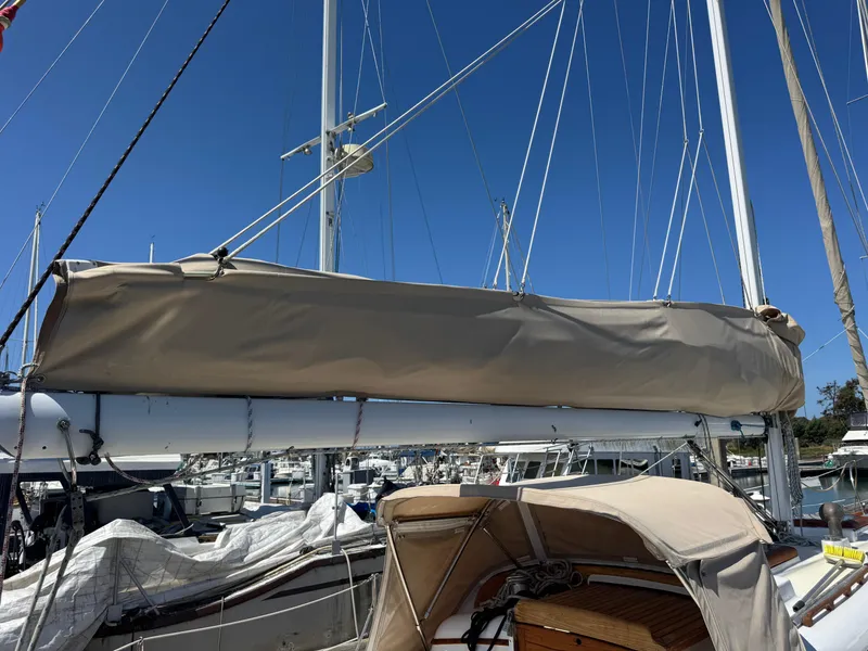 Slide: The Image of 1970 Cheoy Lee Luders 36 sailboat with covered boom, docked in marina. - 37