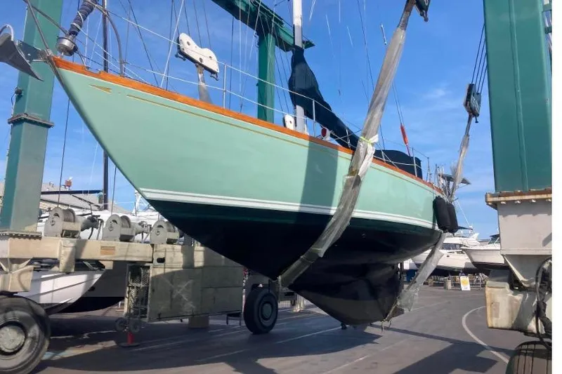 Slide: The Image of 1970 Cheoy Lee Luders 36 sailboat in dry dock, suspended by a crane. - 41