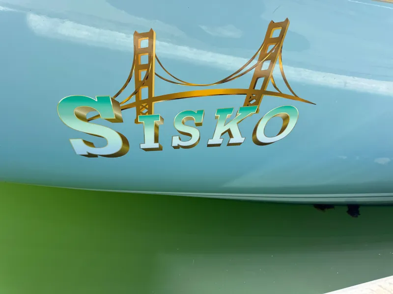 Slide: The Image of Cheoy Lee Luders 36 sailboat, 1970, with 'Sisko' and bridge graphic on hull. - 7