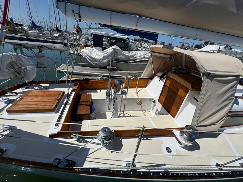 Slide: The Image of 1970 Cheoy Lee Luders 36 sailboat with wooden accents docked in a marina. - 8