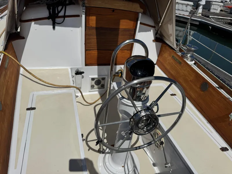 Slide: The Image of Cockpit of a 1970 Cheoy Lee Luders 36 sailboat with a metal steering wheel. - 9