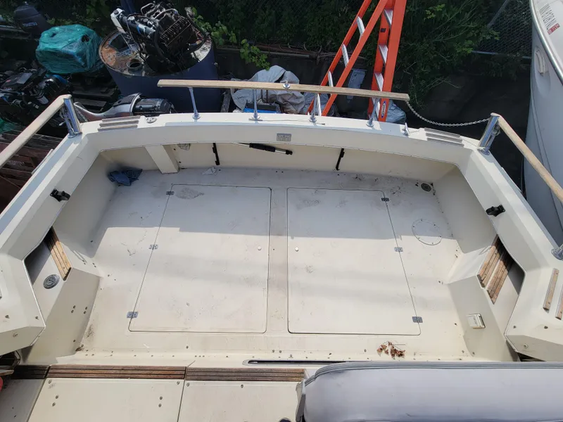 Slide: The Image of 1979 Bayliner 3250 boat docked at marina, featuring sleek design and spacious deck. - 1