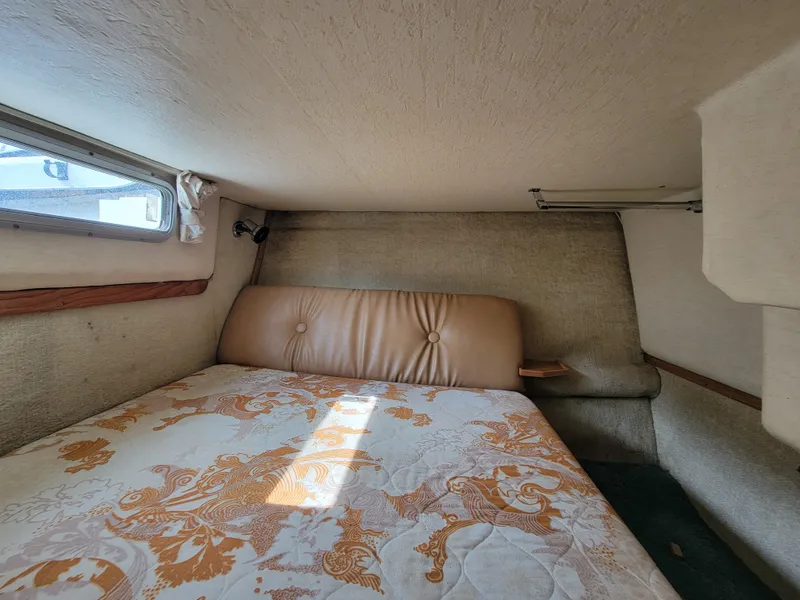 Slide: The Image of Interior cabin of a 1979 Bayliner 3250 boat with a cozy sleeping area. - 17