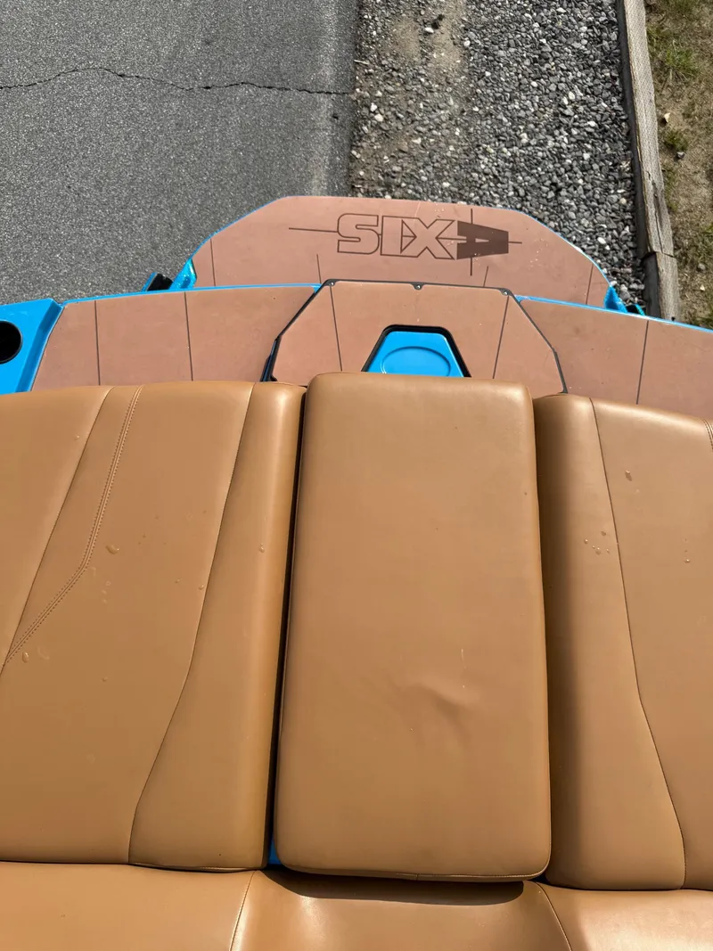 Slide: The Image of Rear view of 2022 Axis T250 boat with tan seating and blue accents. - 10