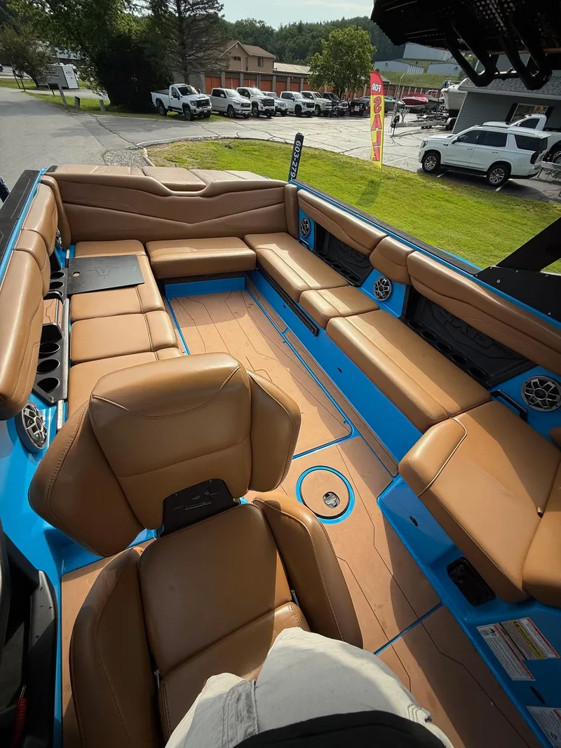 Slide: The Image of 2022 Axis T250 boat interior with tan leather seating and blue accents. - 17