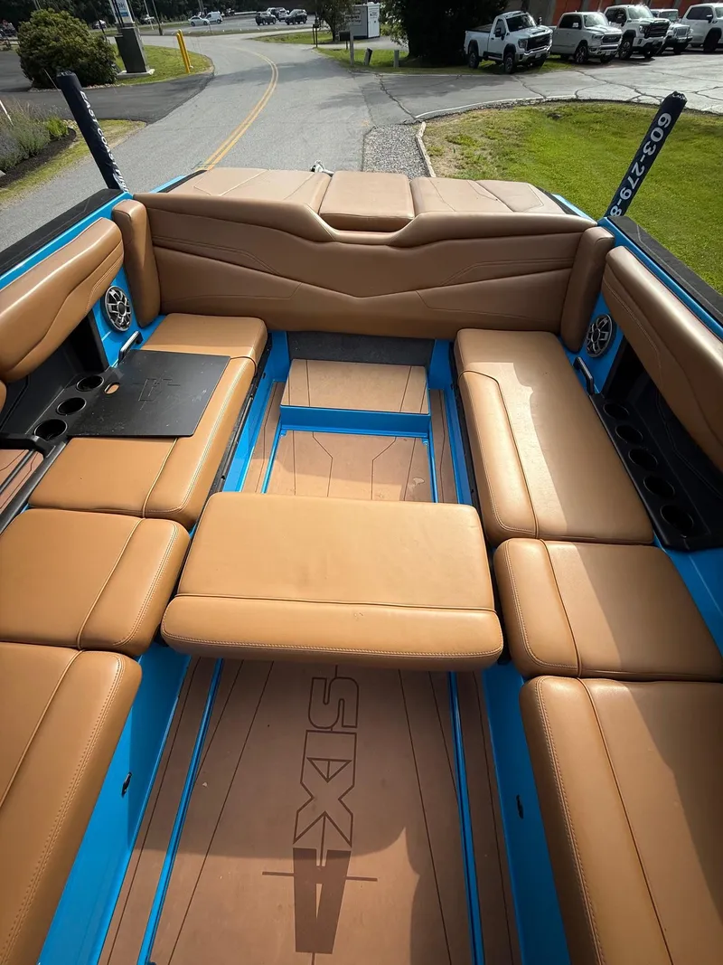 Slide: The Image of 2022 Axis T250 boat interior with tan seating and blue accents. - 18
