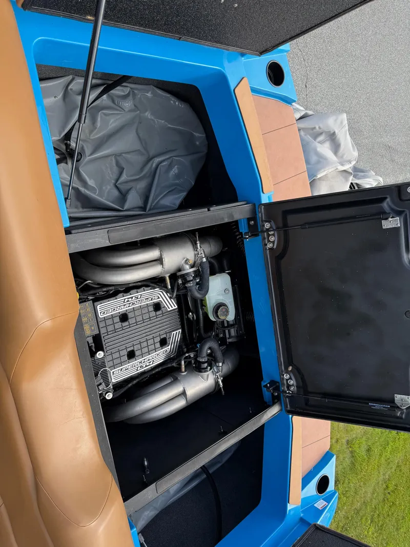 Slide: The Image of 2022 Axis T250 boat engine compartment with open hatch, showcasing engine details. - 20