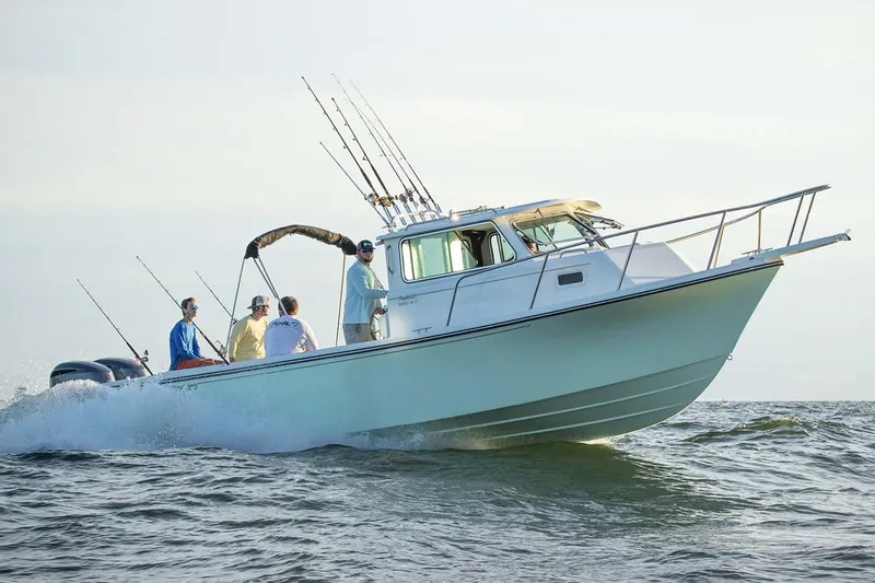 Slide: The Image of 2025 Parker 2820 XLD Sport Cabin boat cruising with passengers on open water. - 4