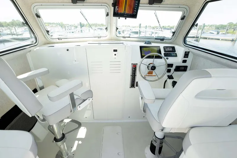 Slide: The Image of 2025 Parker 2820 XLD Sport Cabin interior with steering wheel and navigation equipment. - 8