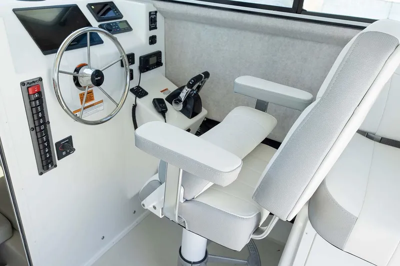 Slide: The Image of 2025 Parker 2820 XLD Sport Cabin helm with steering wheel and control panel. - 9