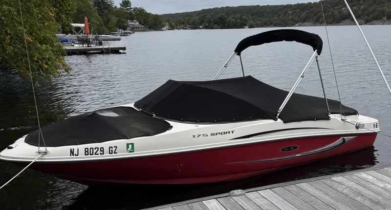 Slide: The Image of 2008 Sea Ray 175 Sport boat docked on a serene lake. - 10