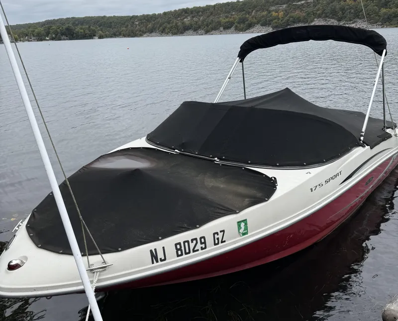 Slide: The Image of 2008 Sea Ray 175 Sport boat with cover on a calm lake. - 11