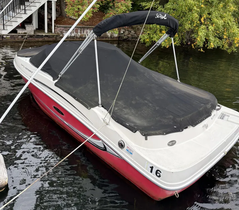Slide: The Image of 2008 Sea Ray 175 Sport boat docked with cover, surrounded by water and greenery. - 12