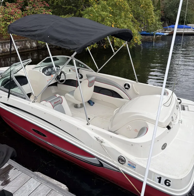 Slide: The Image of 2008 Sea Ray 175 Sport boat docked by a lake with canopy and seating. - 14