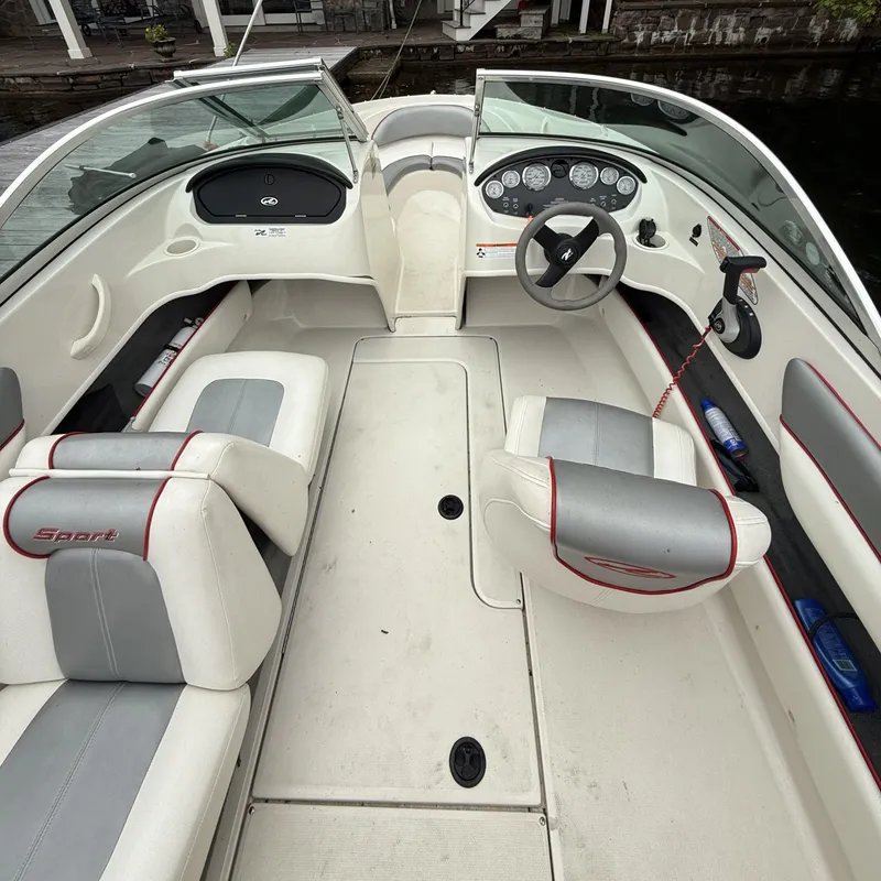 Slide: The Image of 2008 Sea Ray 175 Sport boat interior with white and gray seating, dashboard, and steering wheel. - 3