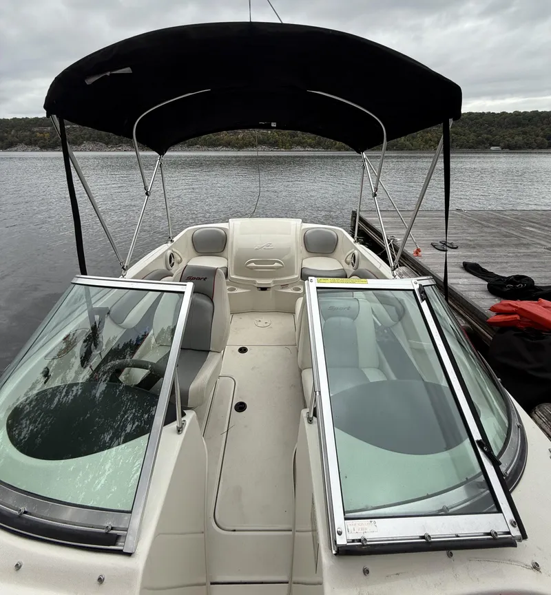 Slide: The Image of 2008 Sea Ray 175 Sport boat with canopy, docked on a calm lake. - 4