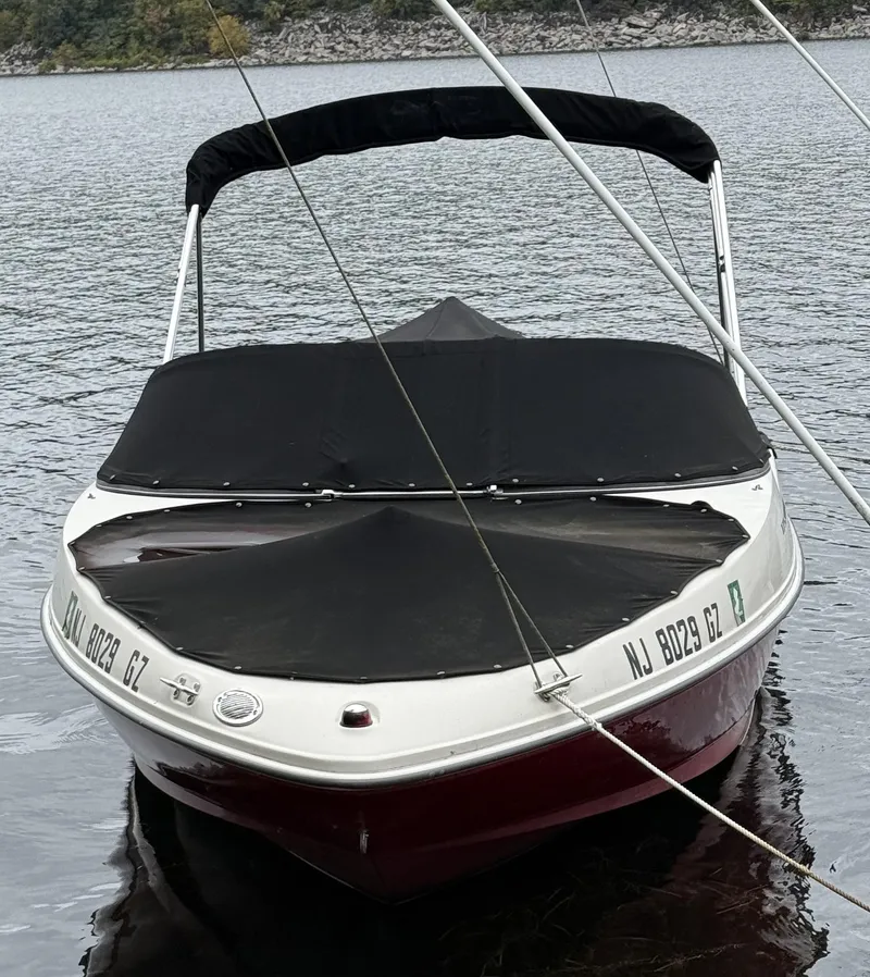 Slide: The Image of 2008 Sea Ray 175 Sport boat with black cover on a calm lake. - 5