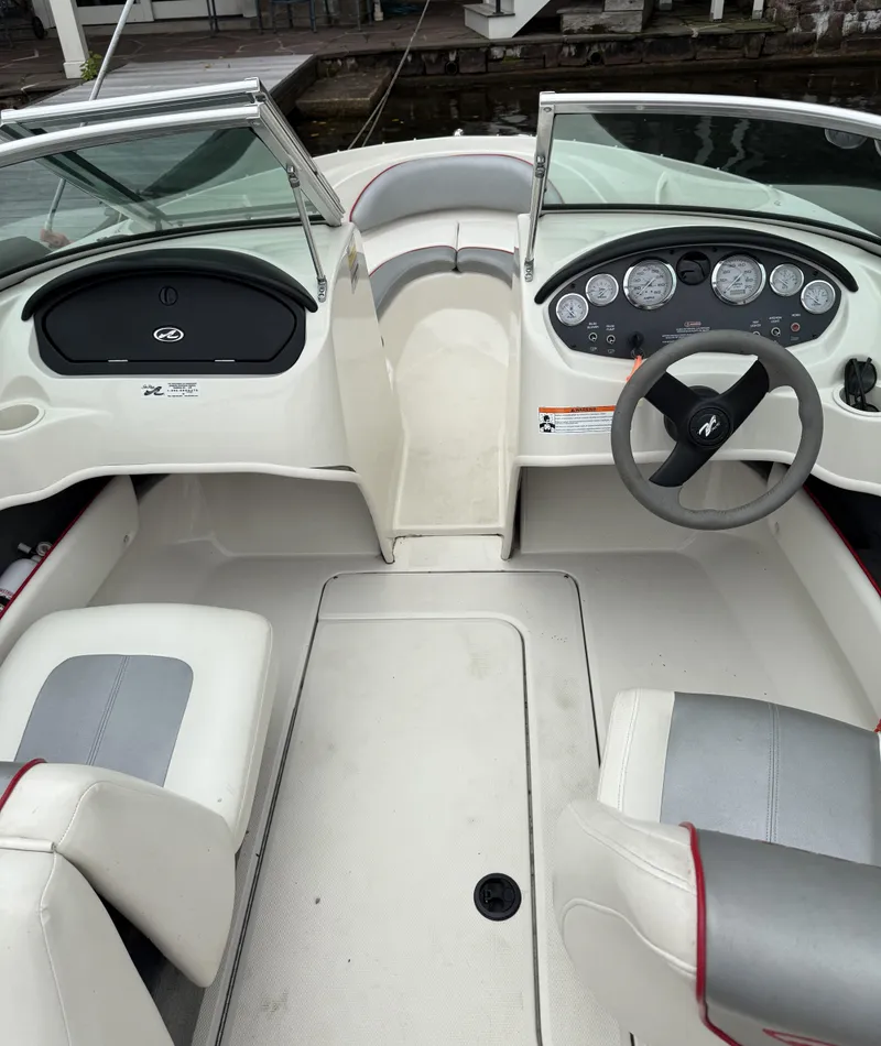 Slide: The Image of 2008 Sea Ray 175 Sport boat interior with steering wheel and dashboard controls. - 6