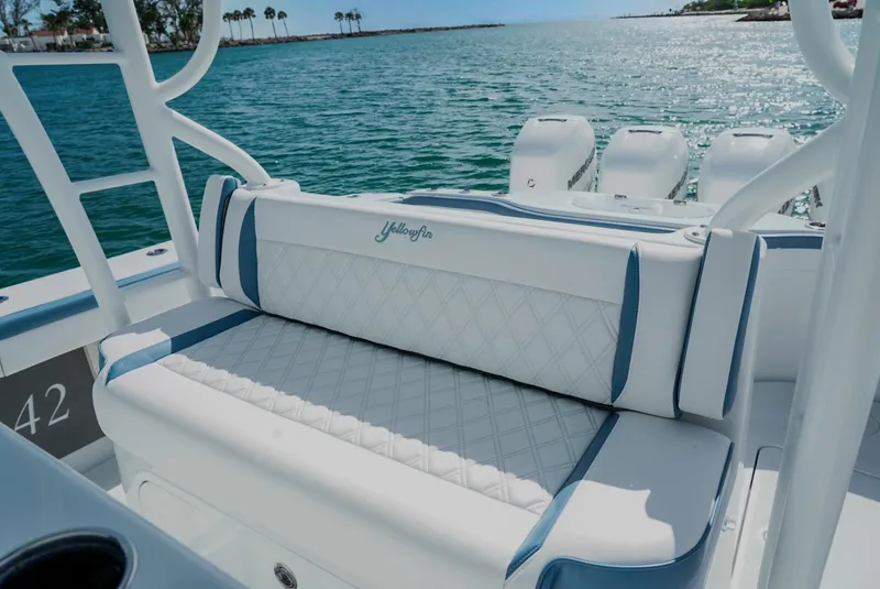 Slide: The Image of 2023 Yellowfin 42 boat with luxurious seating and multiple outboard engines on a sunny day. - 10