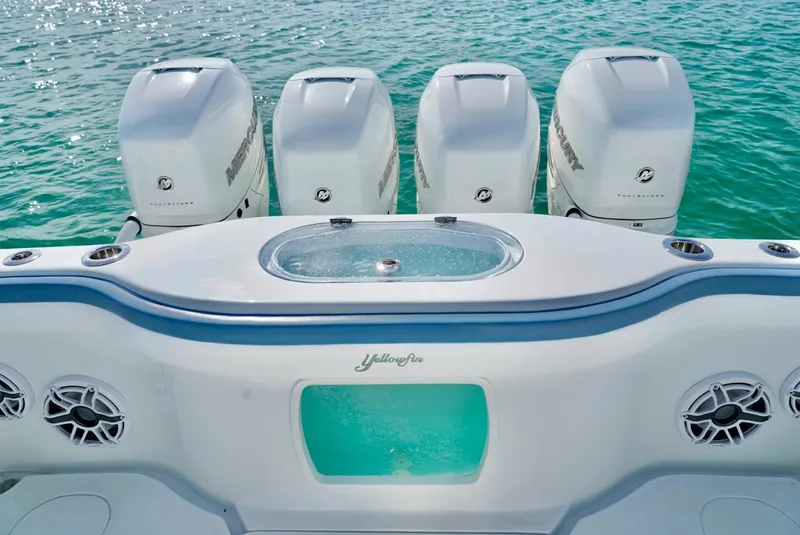 Slide: The Image of 2023 Yellowfin 42 boat with four Mercury outboard engines on turquoise water. - 12