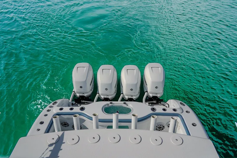 Slide: The Image of 2023 Yellowfin 42 boat with four outboard engines on turquoise water. - 13