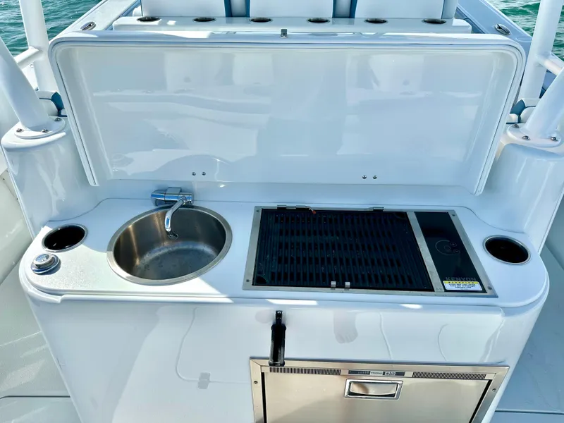 Slide: The Image of Outdoor kitchen on 2023 Yellowfin 42 boat with sink and grill. - 15