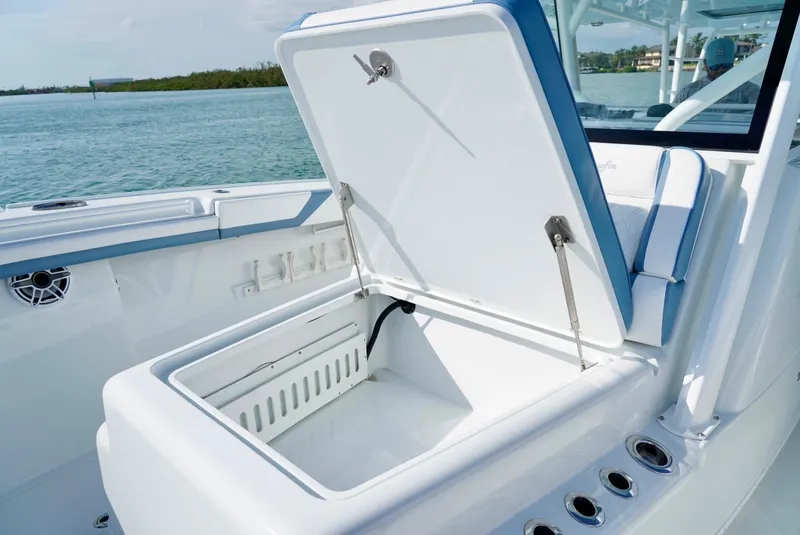 Slide: The Image of Open storage compartment on 2023 Yellowfin 42 boat, with ocean view in background. - 16