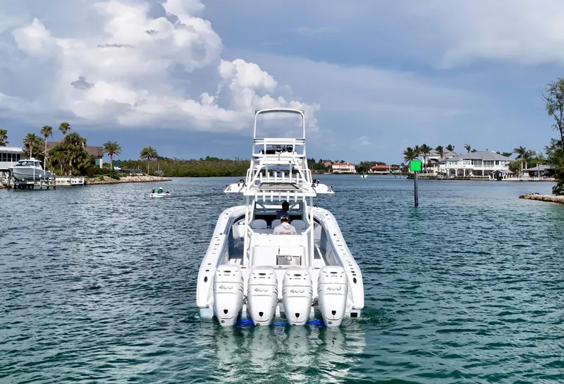 Slide: The Image of 2023 Yellowfin 42 boat cruising in a scenic coastal waterway. - 2