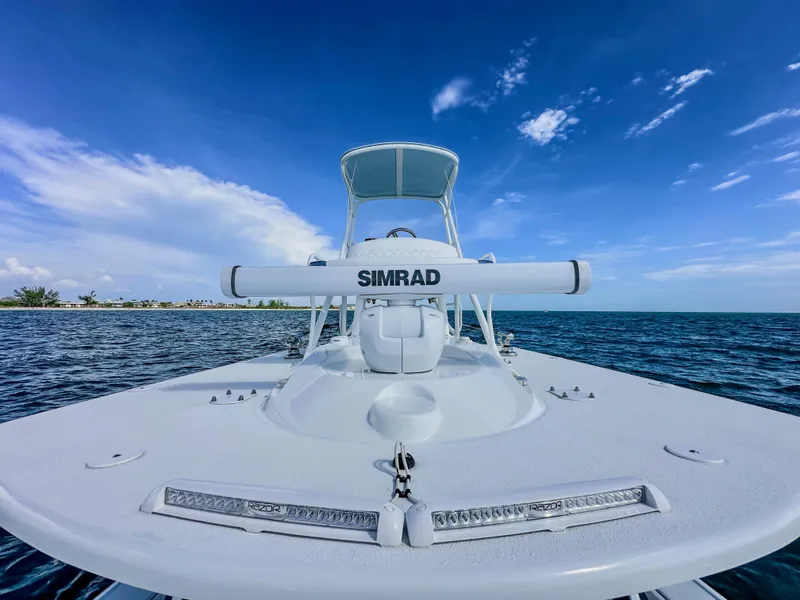 Slide: The Image of 2023 Yellowfin 42 boat with Simrad equipment on open water under clear blue sky. - 21