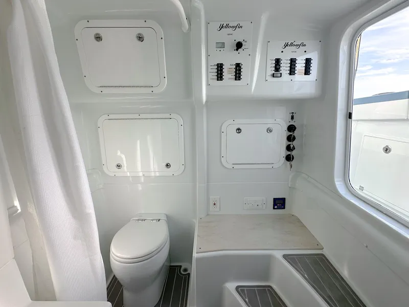 Slide: The Image of 2023 Yellowfin 42 boat interior with toilet, control panels, and window view. - 27