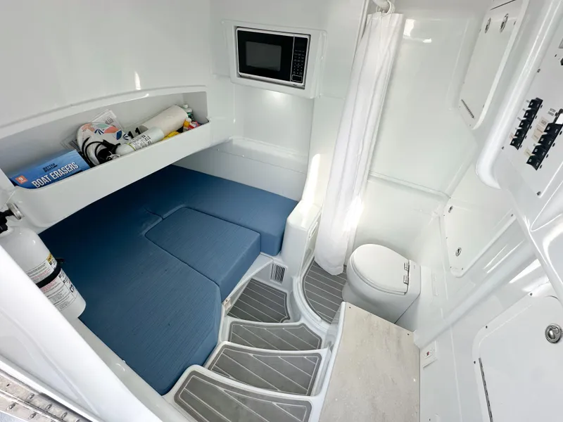Slide: The Image of 2023 Yellowfin 42 cabin interior with bed, microwave, and toilet. - 28