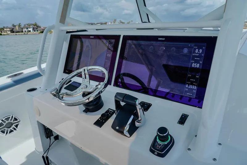Slide: The Image of 2023 Yellowfin 42 boat dashboard with advanced navigation controls and dual displays. - 3