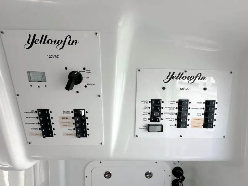 Slide: The Image of Control panels on a 2023 Yellowfin 42 boat, featuring 120VAC and 12VDC systems. - 30