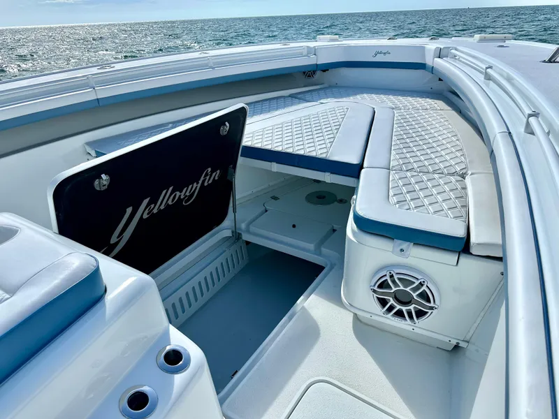 Slide: The Image of 2023 Yellowfin 42 boat interior with cushioned seating and ocean view. - 8